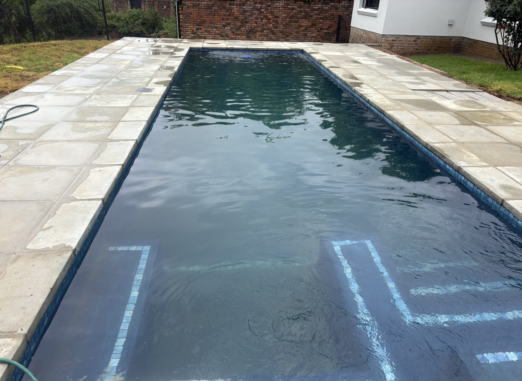 Concrete coping and waterline detail on custom pool